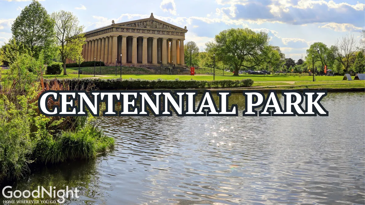 This image showcases a serene view of The Parthenon structure set amidst lush greenery and a calm water surface, capturing the tranquility and grandeur of Centennial Park. The iconic Parthenon-like architecture is a recognizable Nashville landmark, with open space for walking, picnicking, and outdoor family activities.