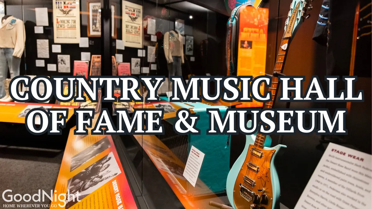 An interior shot from the Country Music Hall of Fame, featuring a guitar, stage wear, and historical posters that invite visitors to explore the vibrant history of country music through interactive exhibits and iconic memorabilia.